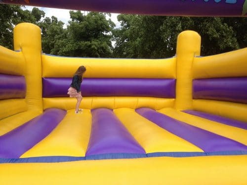 bouncy castle hire, yellow and purple bouncer